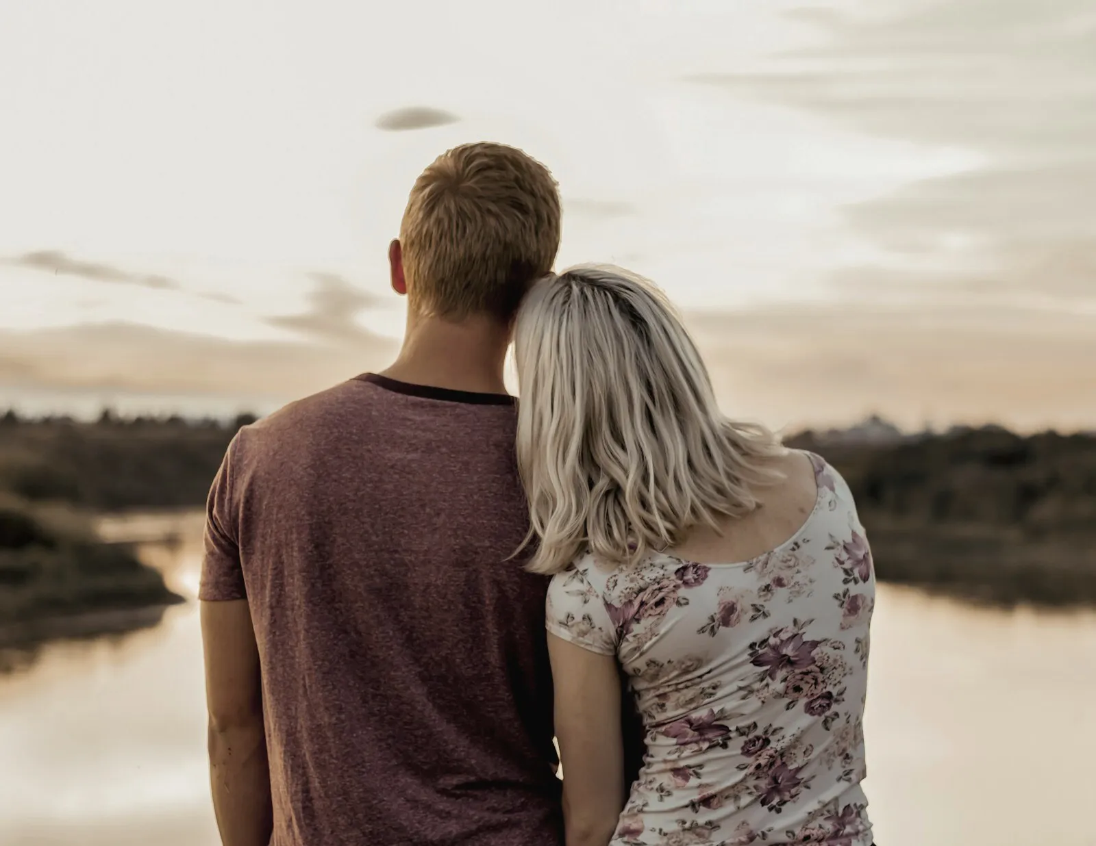 A couple standing together looking out over open water