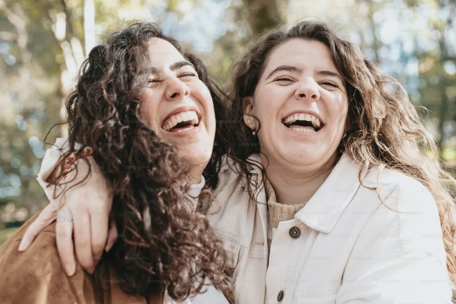 Two women laughing together outdoors