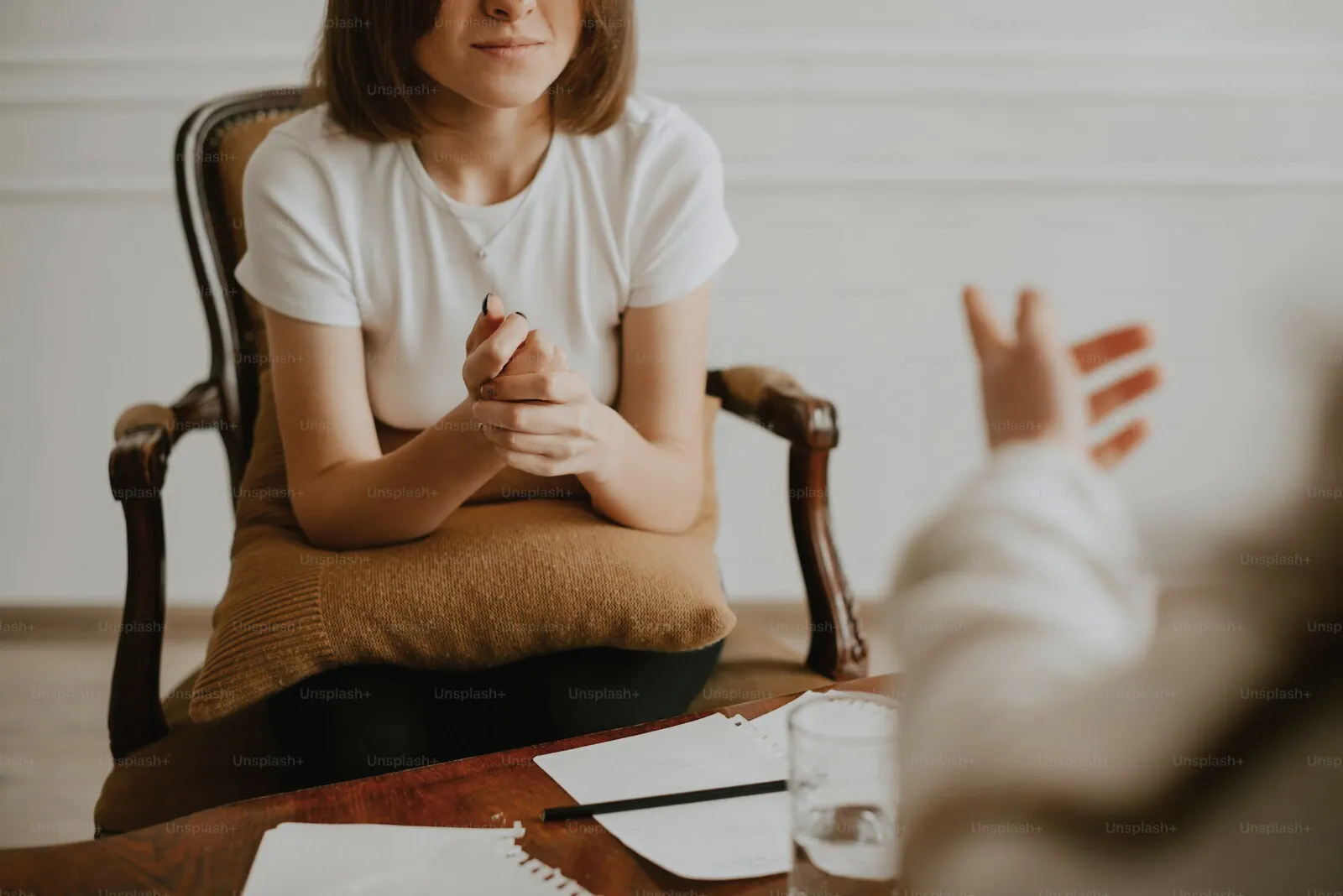 A person talking with their therapist in a quiet room