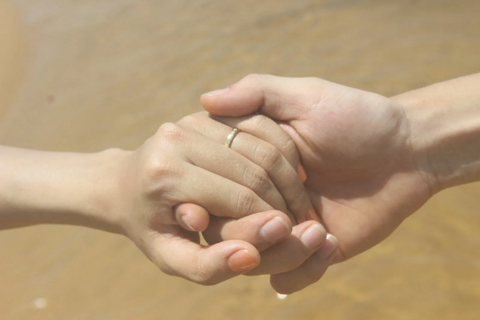 Two hands clasped together
