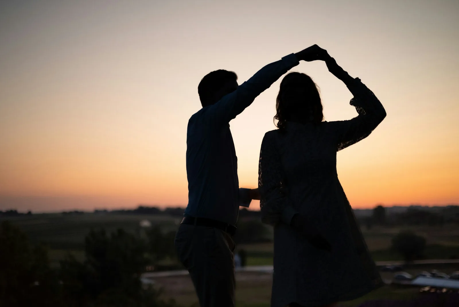 A couple dancing slowly in a spacious, light-filled room