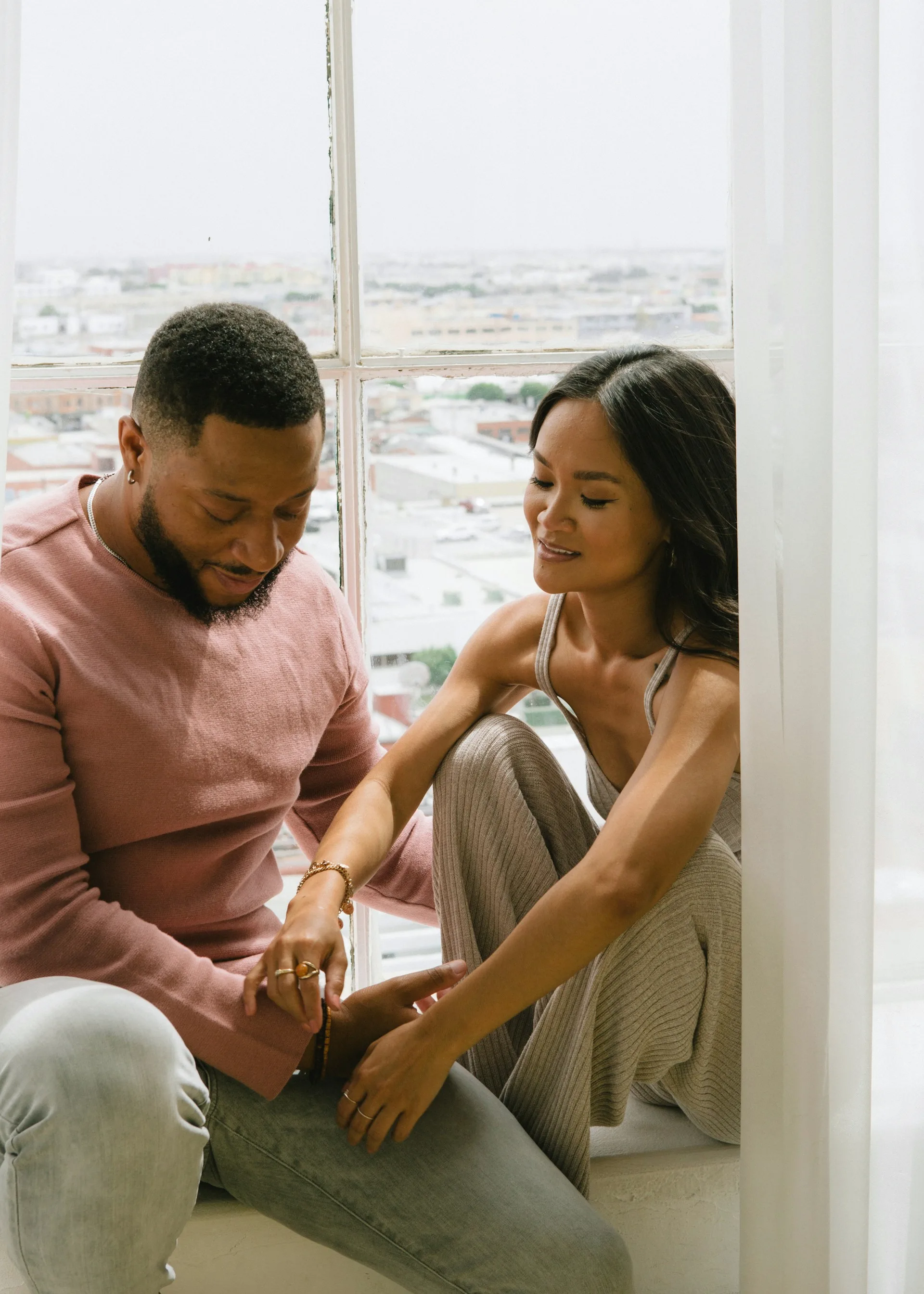 A couple sitting close together, relaxed and connected