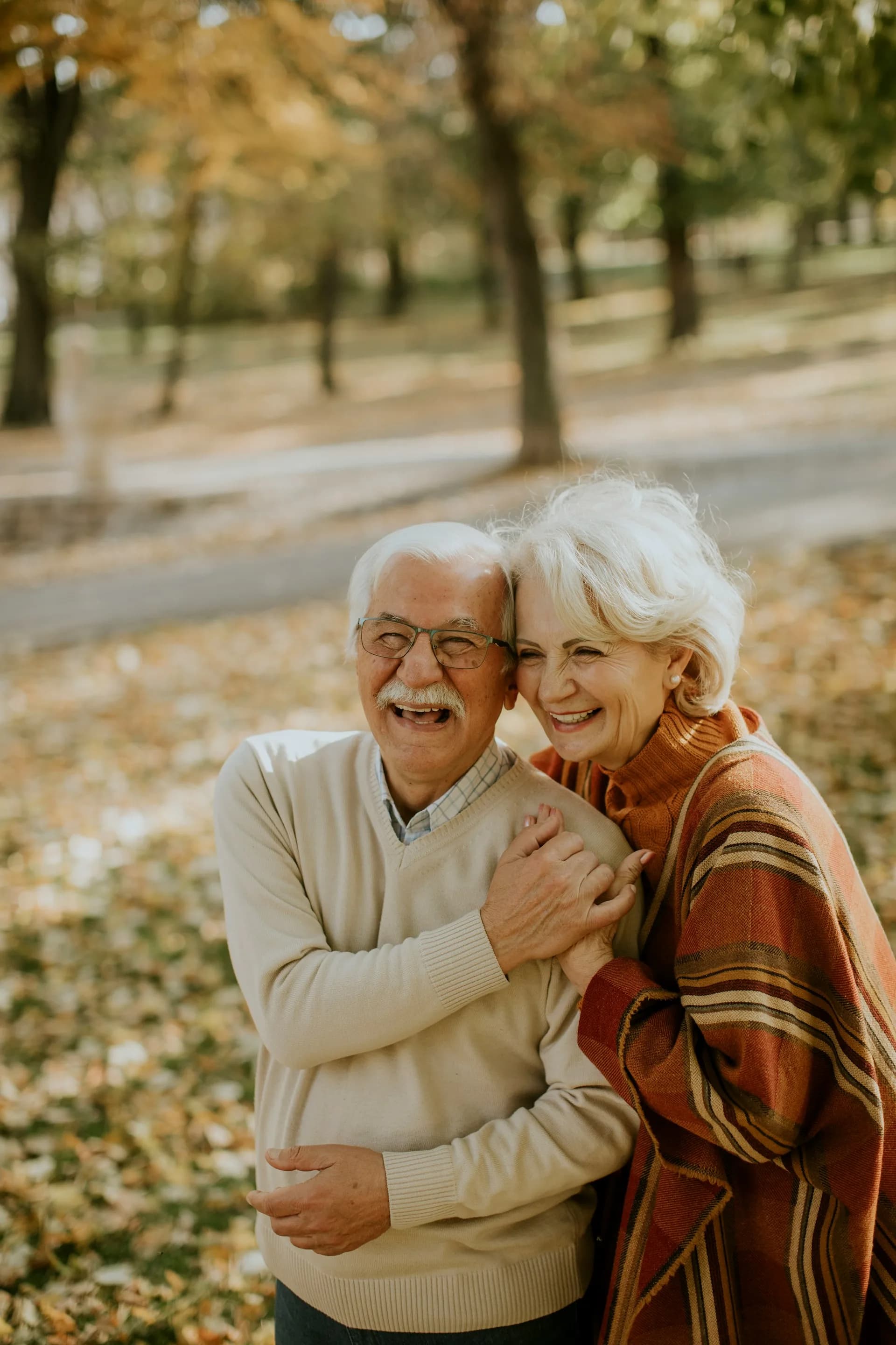 An older couple sitting close together at home