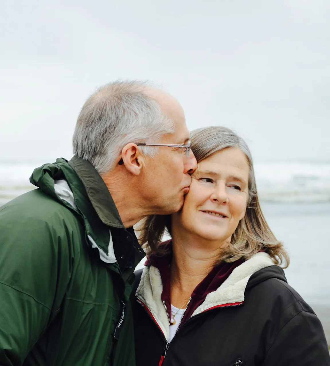 An older couple walking a boardwalk together