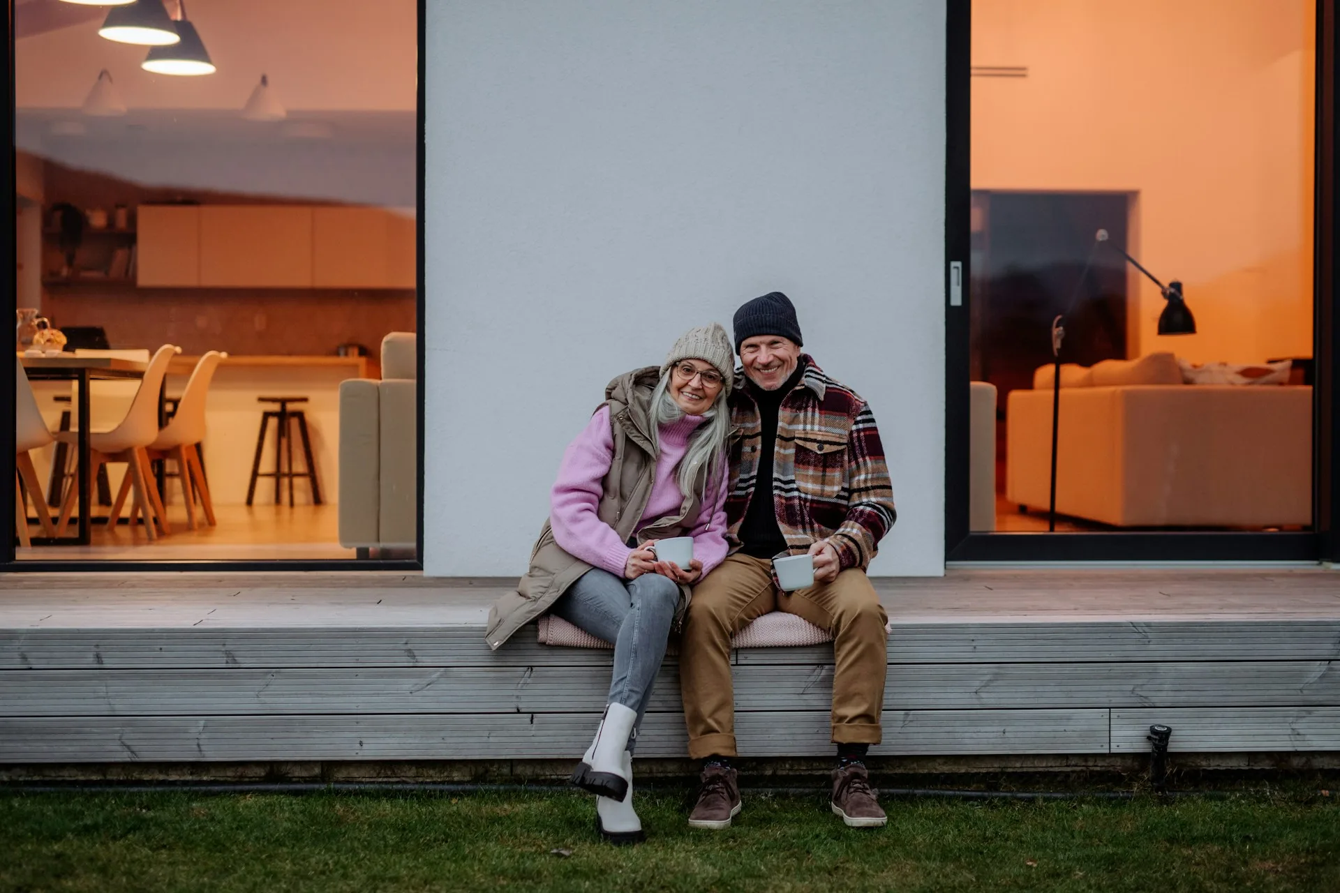 A couple sitting together on the floor at home in quiet conversation