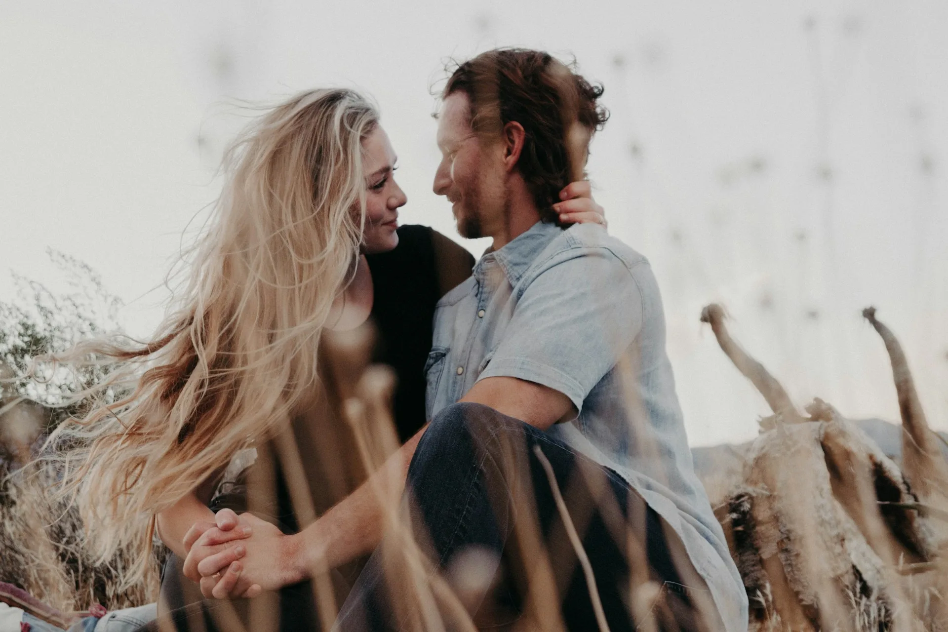 A couple standing close and relaxed together, looking hopeful about their relationship